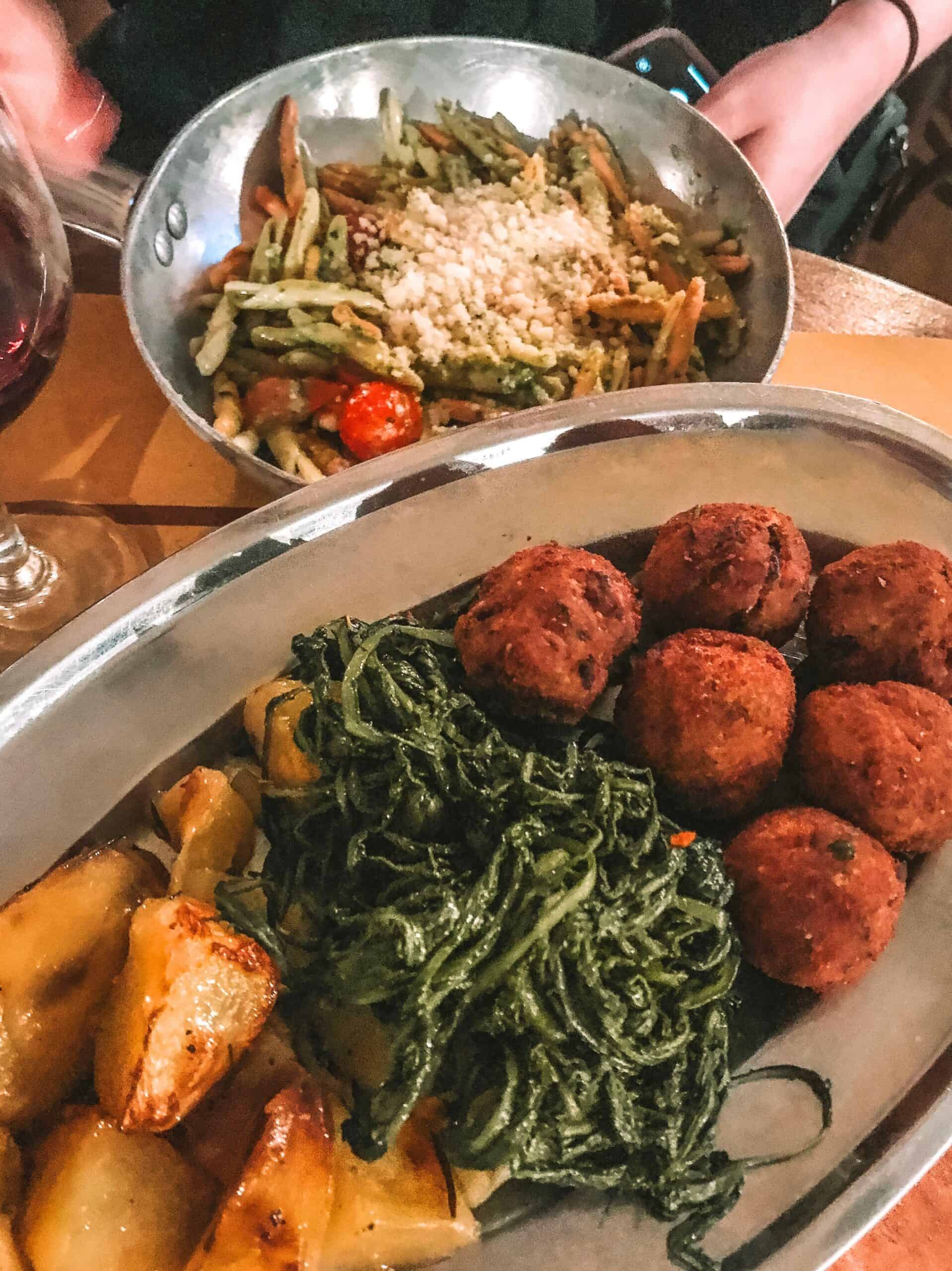 Homemade pasta and pesto and eggplant meatballs with roasted potatoes from Tonnarello. 