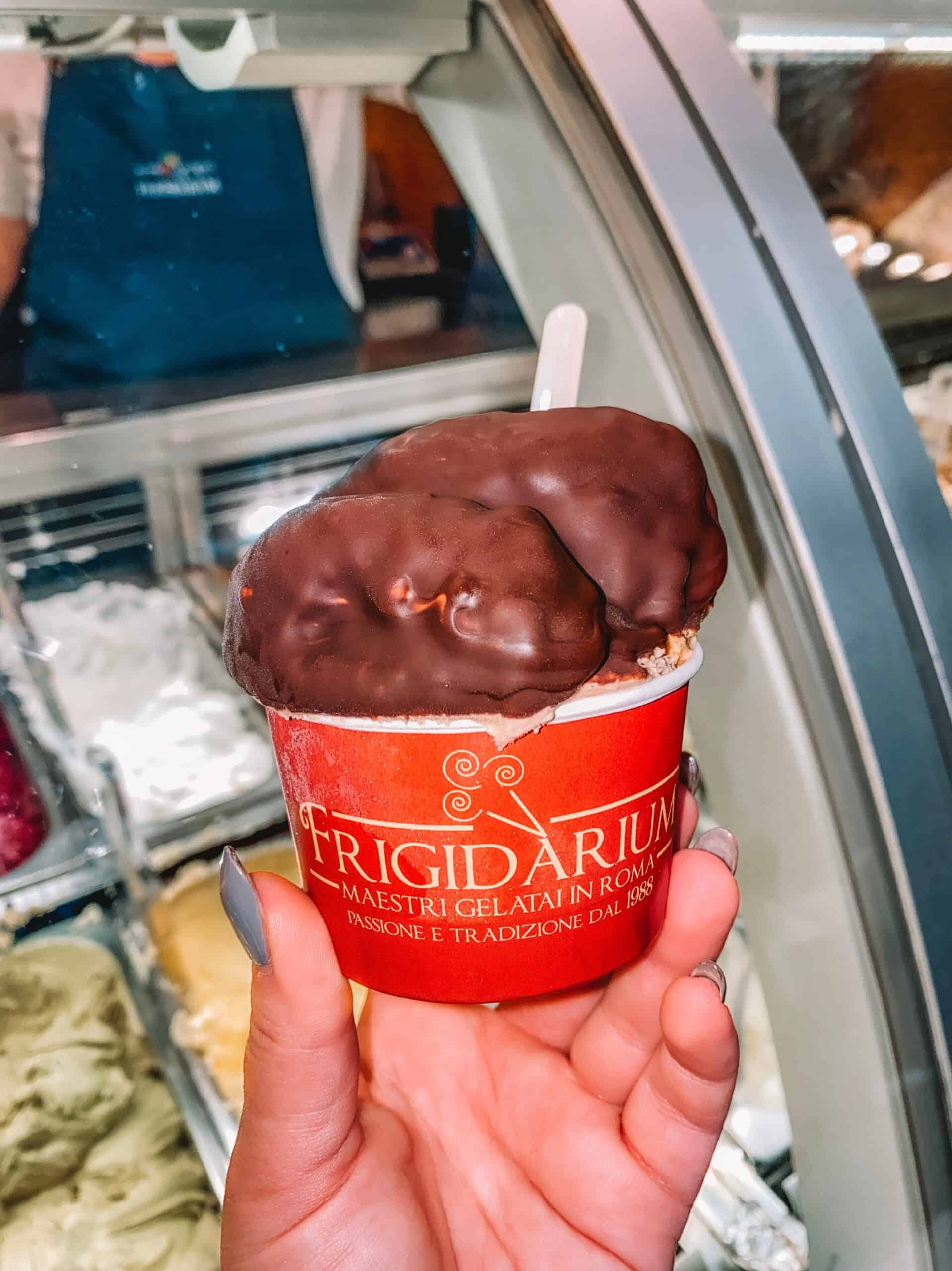 A cup of gelato from Frigidarium covered in chocolate shell. 