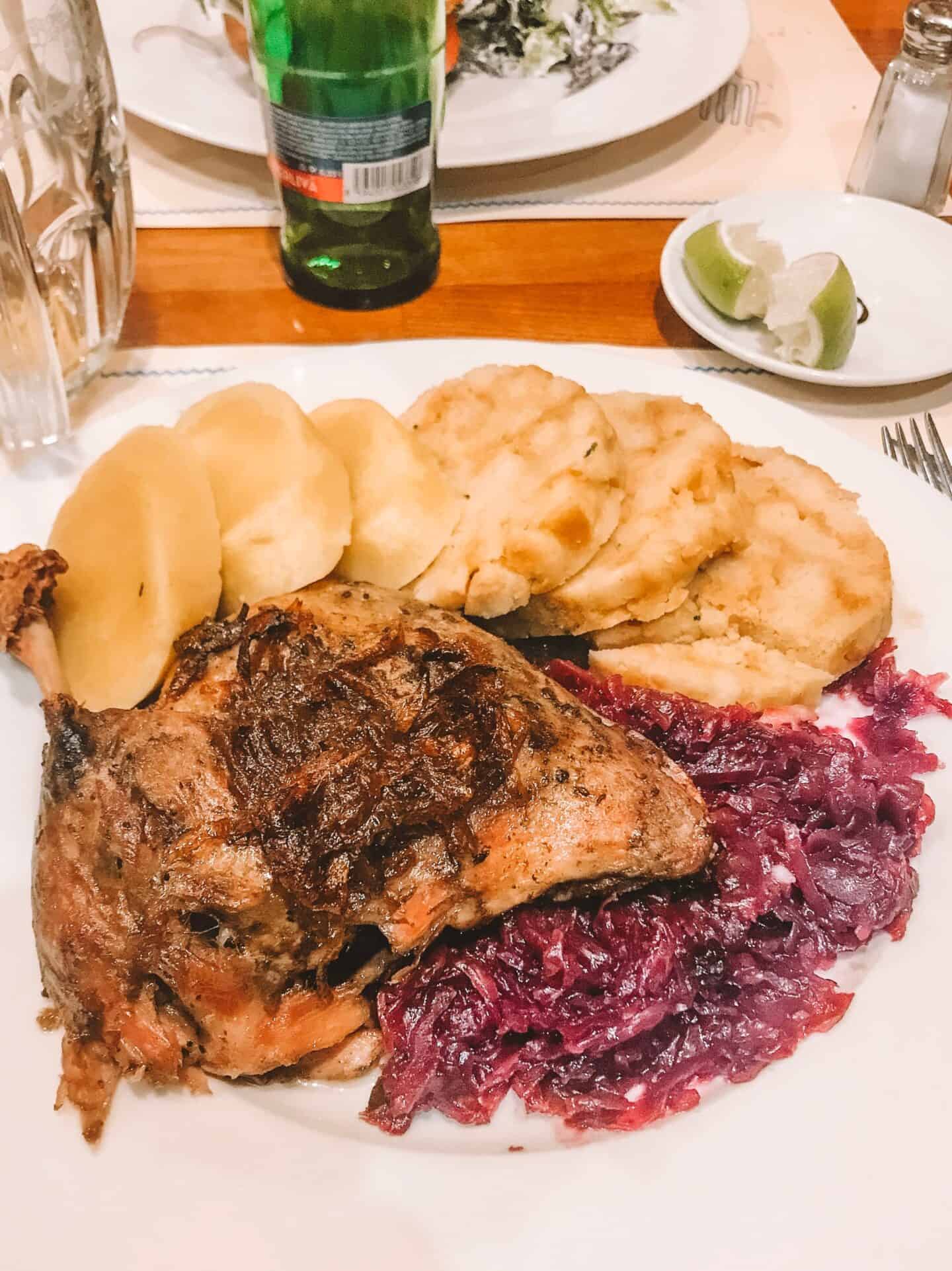 A heaping plate of roasted duck, potato pancakes and sauerkraut from U Bulinu Prague.