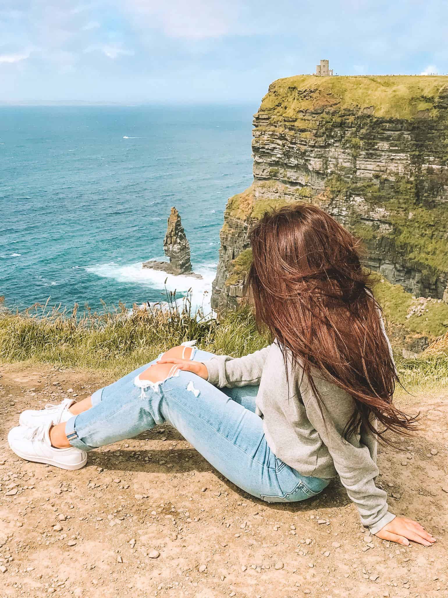 Me sitting on the edge at the Cliffs of Moher on our day trip from Dublin. 