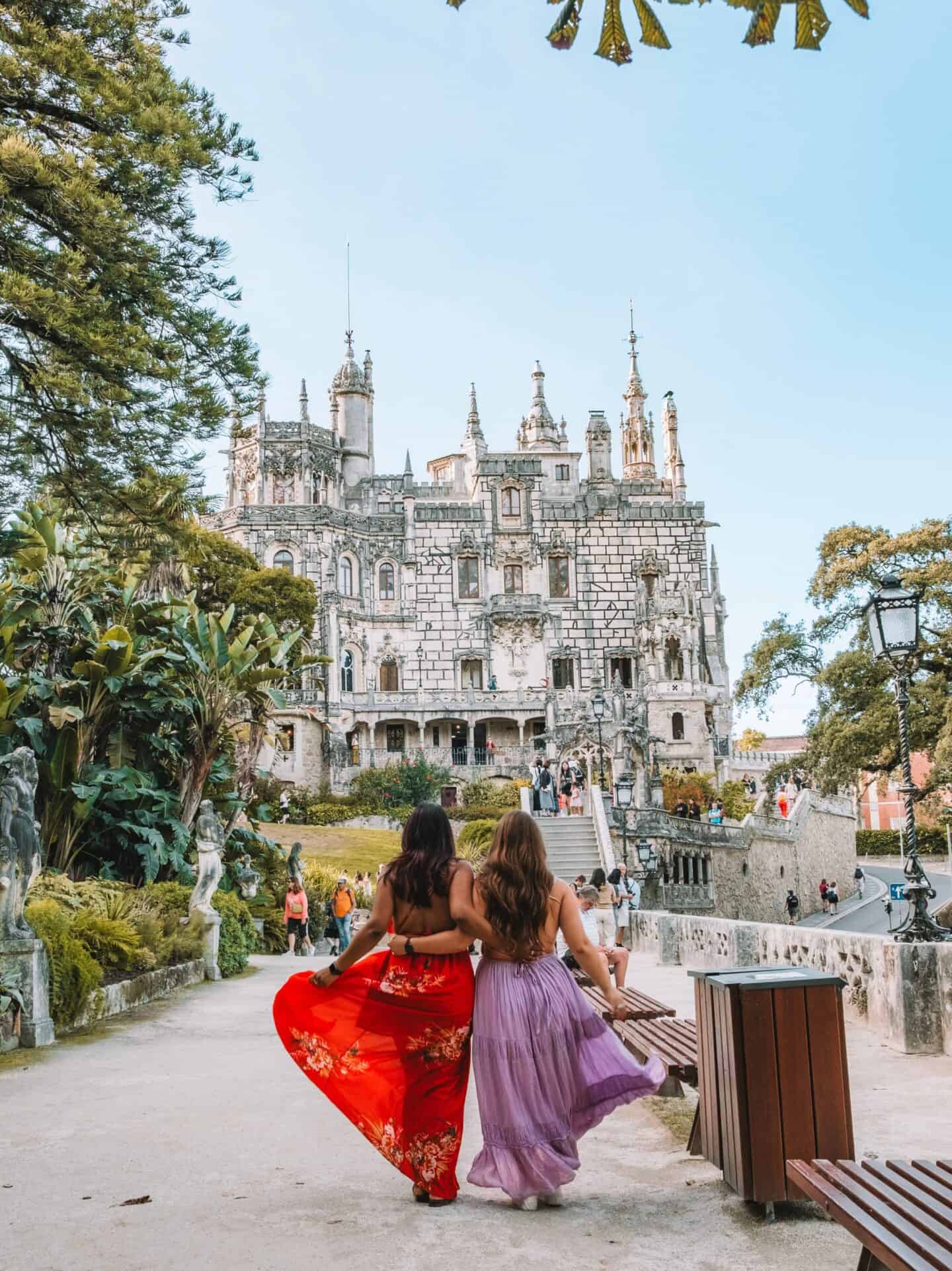 My friend and I posing in long dresses in front of the Quinta da Regaleira. 
