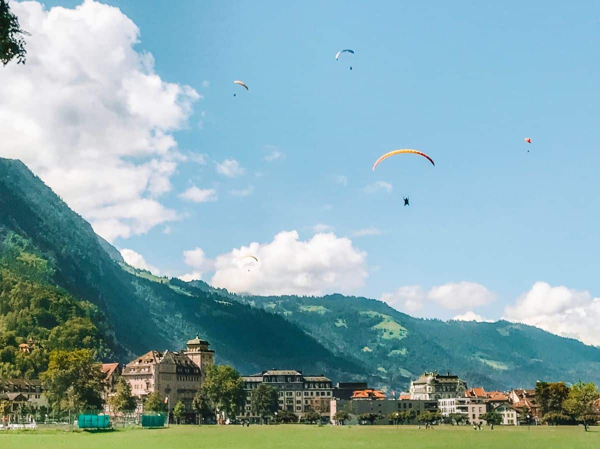 Paragliders and skydivers landing in Interlaken valley. 