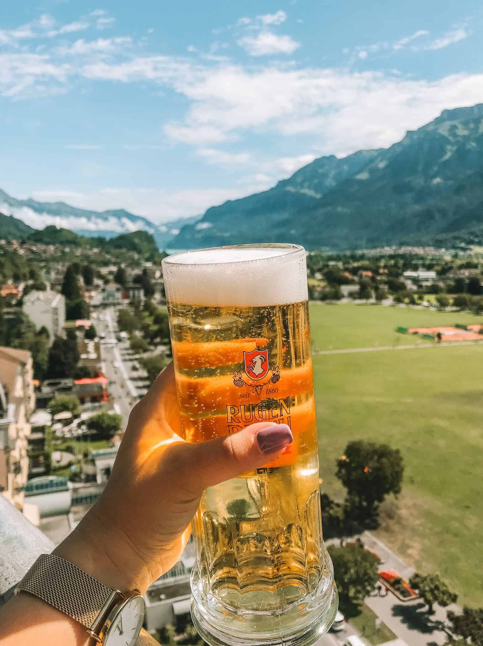 A drink from the Metropole Rooftop Bar – a must-add viewpoint to your Interlaken itinerary. 