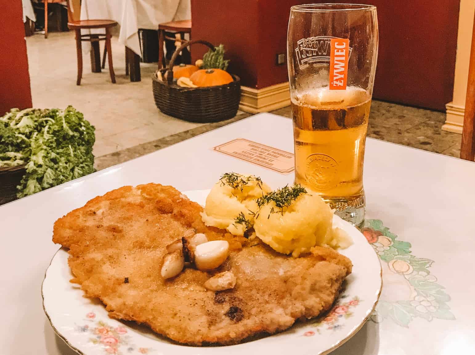 A huge piece of kotlet schabowy complete with two scoops of mashed potatoes is a delicious Krakow traditional food