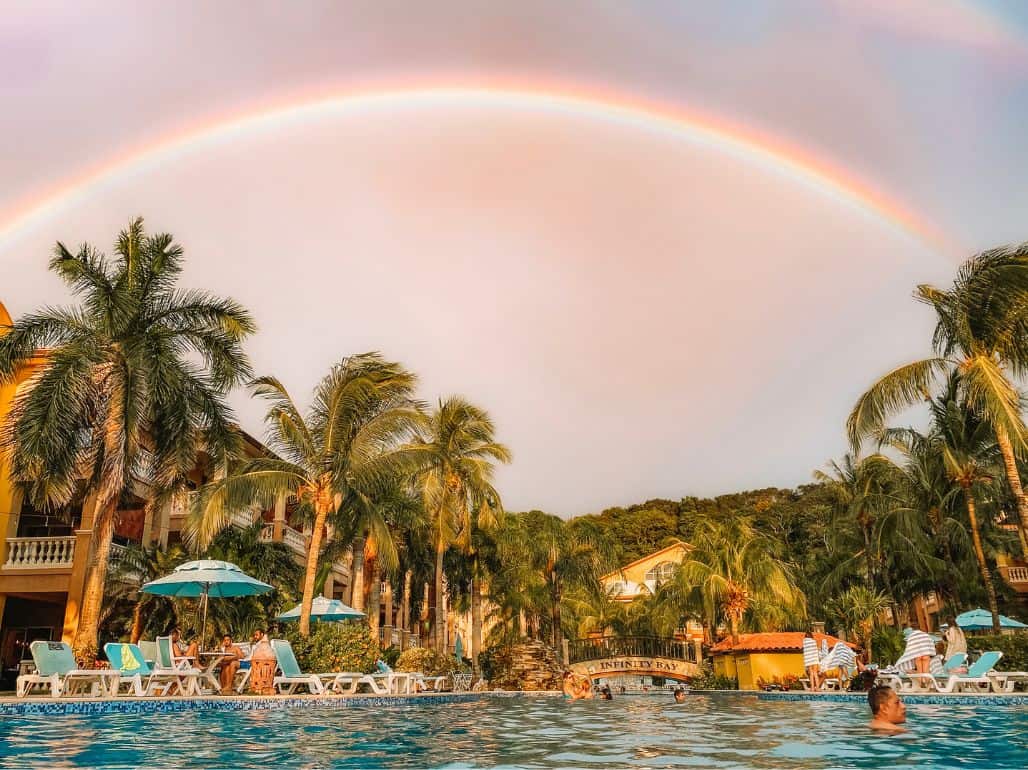 A rainbow over the massive swimming pool at Infinity Bay Resort. 
