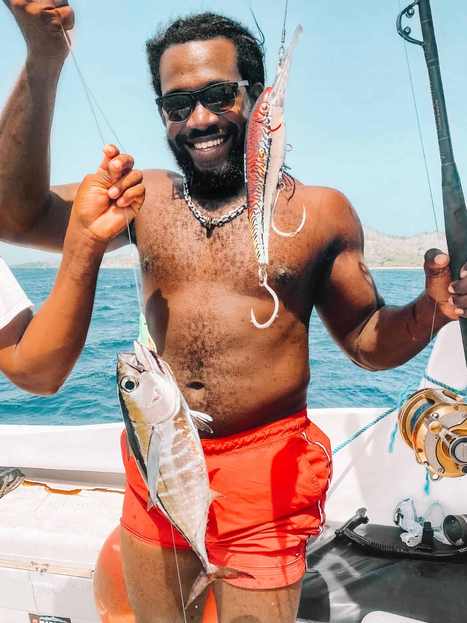 My friend with a tuna we caught on a fishing charter in Roatan 