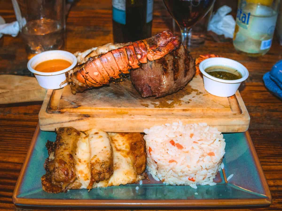 A hearty grilled lobster tail paired with steak grilled to perfection from Argentinian Grill West Bay. 