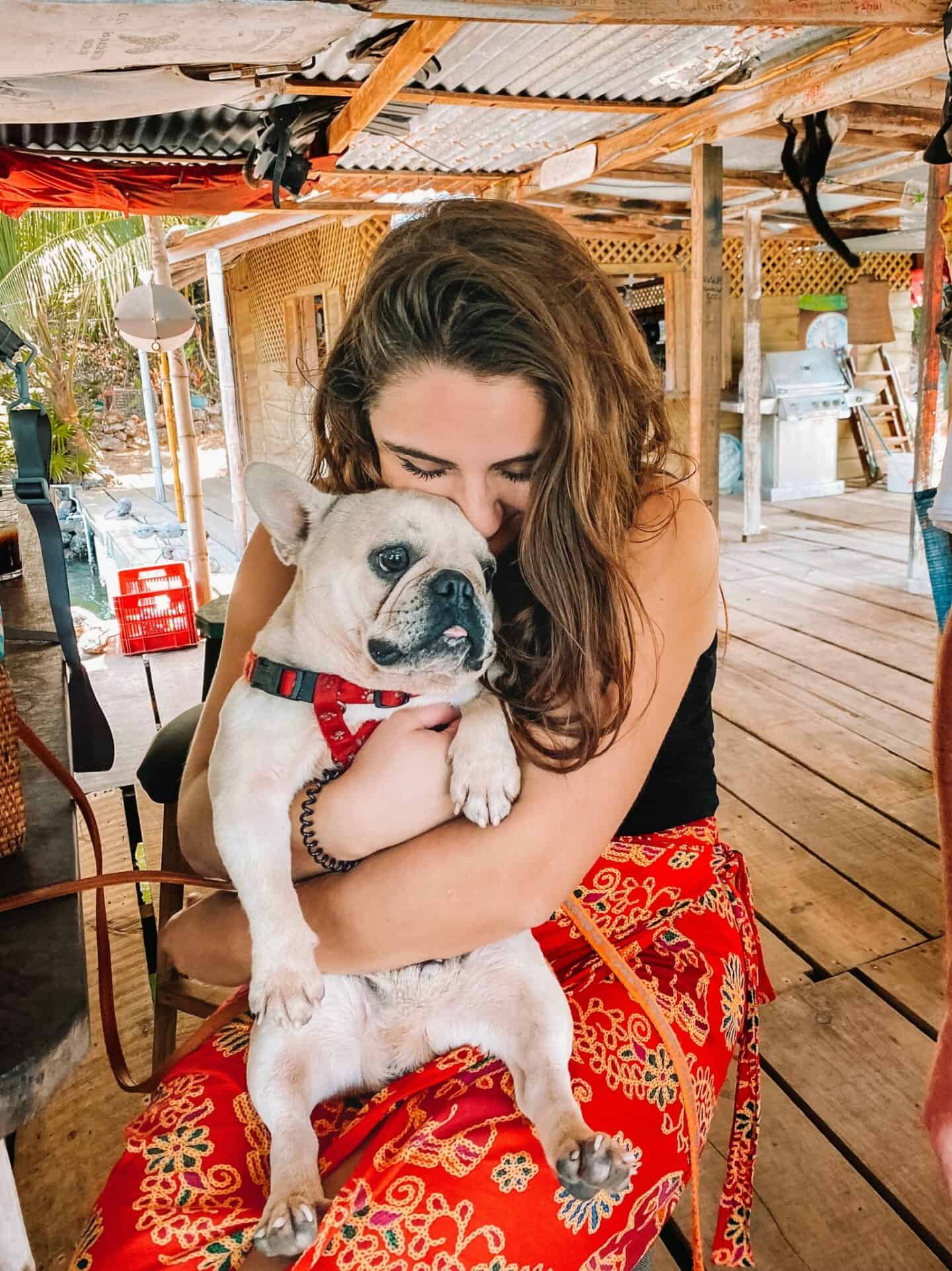 Snuggling a French Bulldog at Hole in the Wall Roatan