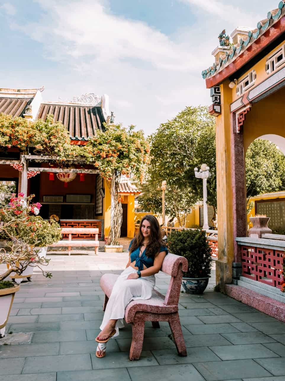 Me sitting on a bench in the open air courtyard of the Hainan Assembly Hall in Hoi An. 