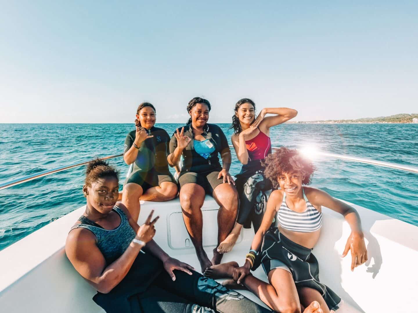 Five local girls pose for the camera while earning their scuba certifications through the Sun Divers Roa Girls Scholarship