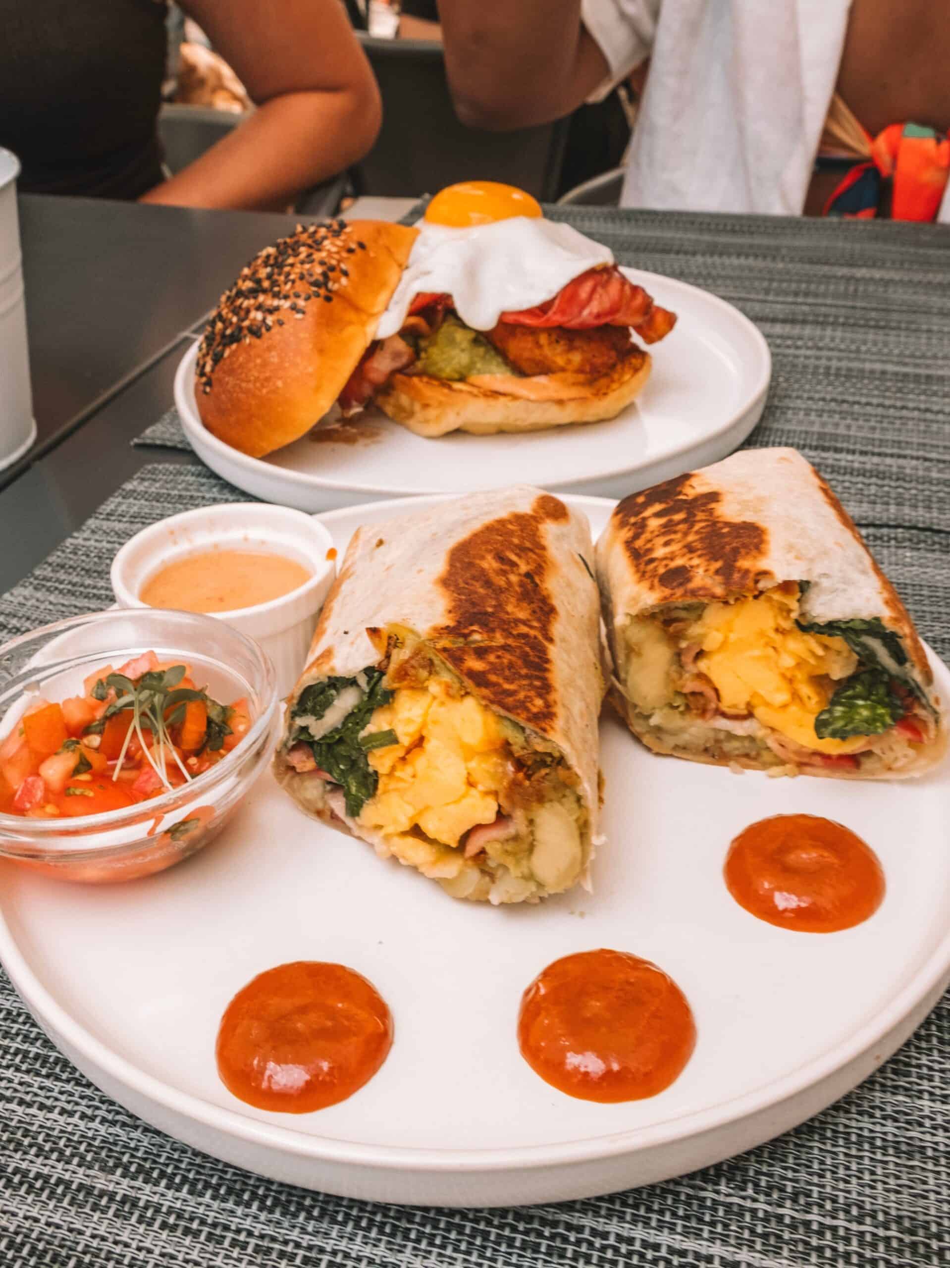 A heaping breakfast sandwich and breakfast burrito from Black and White Lagos. 