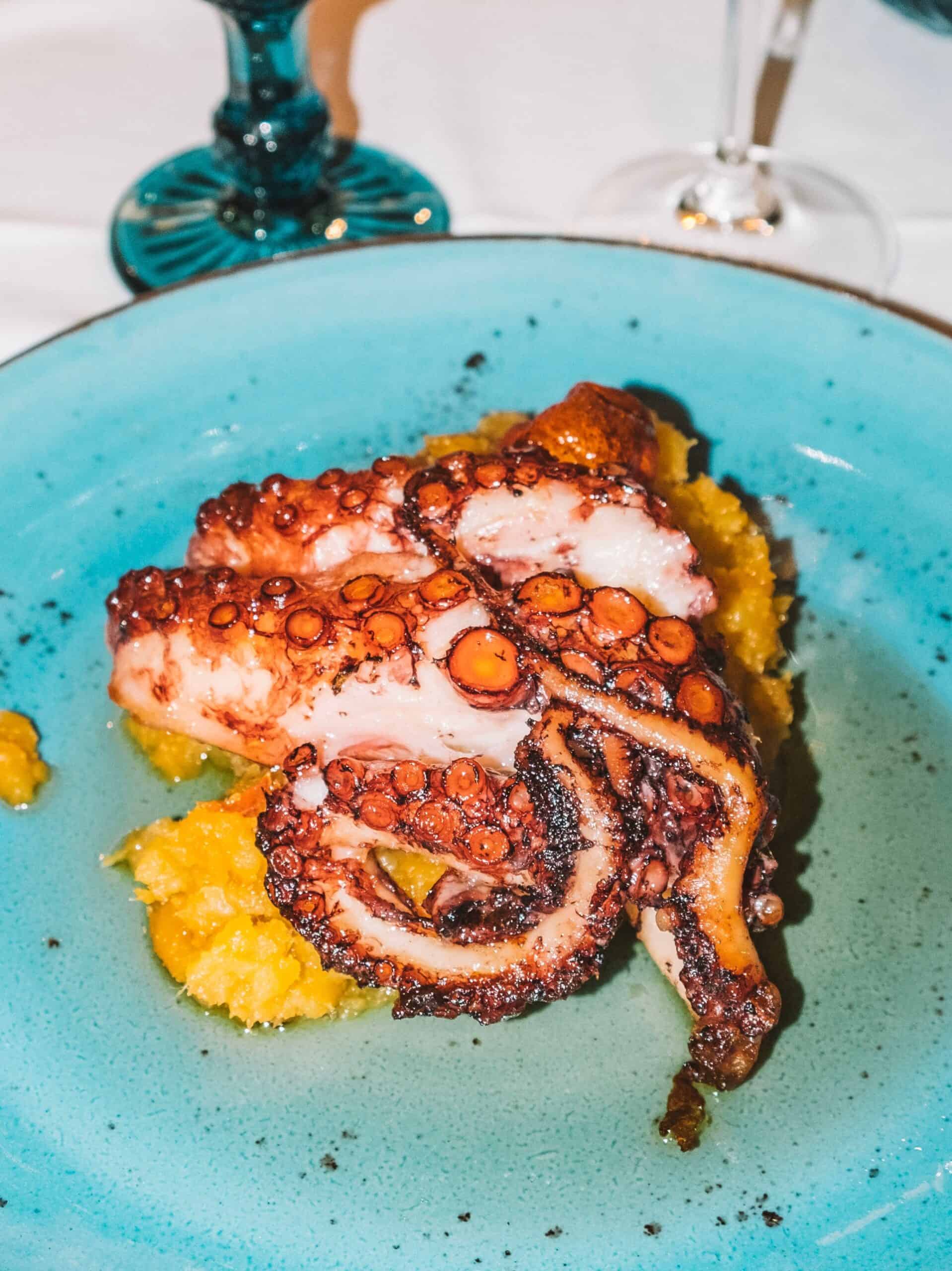 A heaping plate of grilled octopus on a bed of sweet potatoes from Farol de Santa Luzia restaurant. 