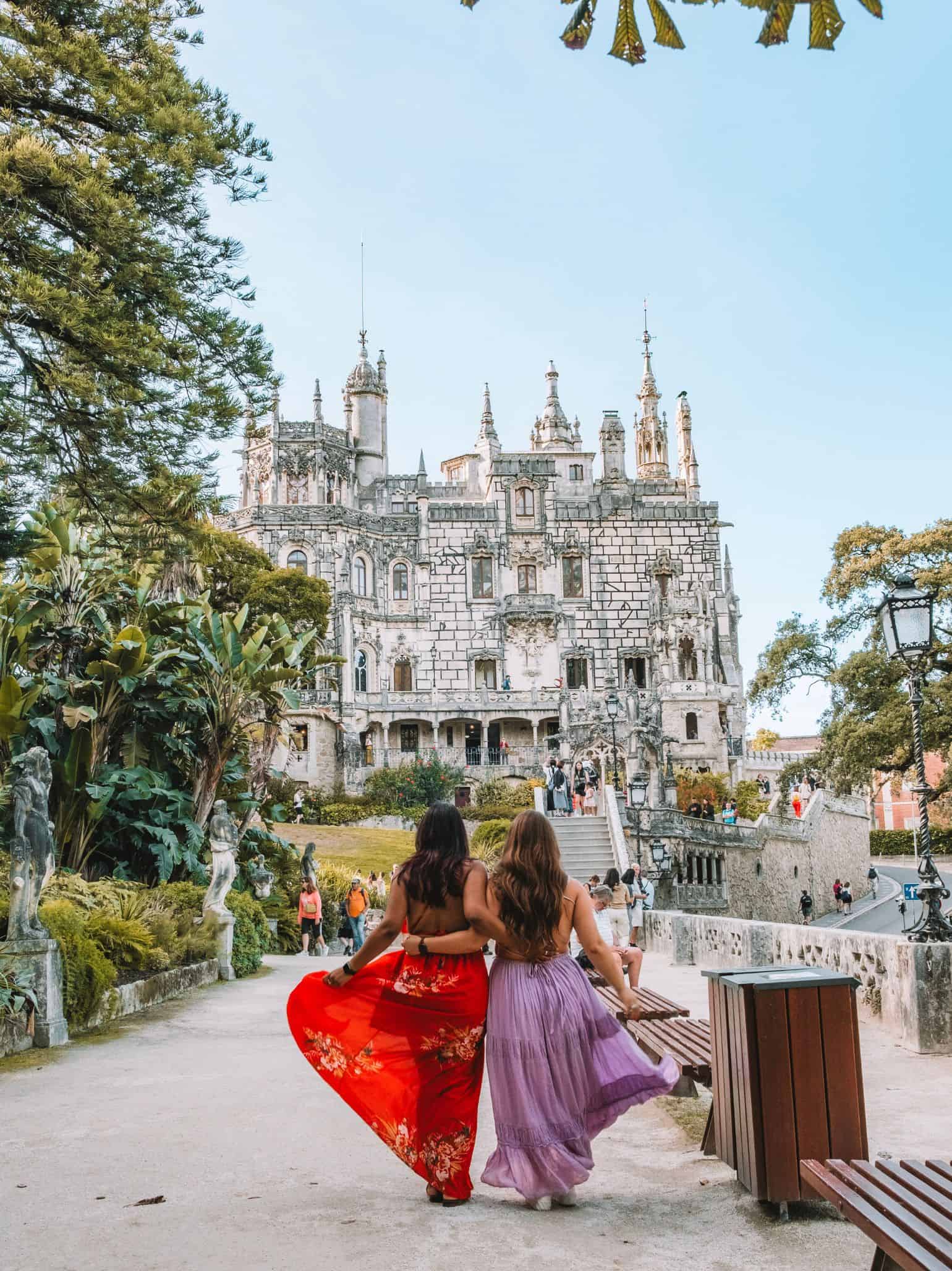 My friend and I posing in flowy dresses in front of the Quinta da Regaleira in Sintra. 