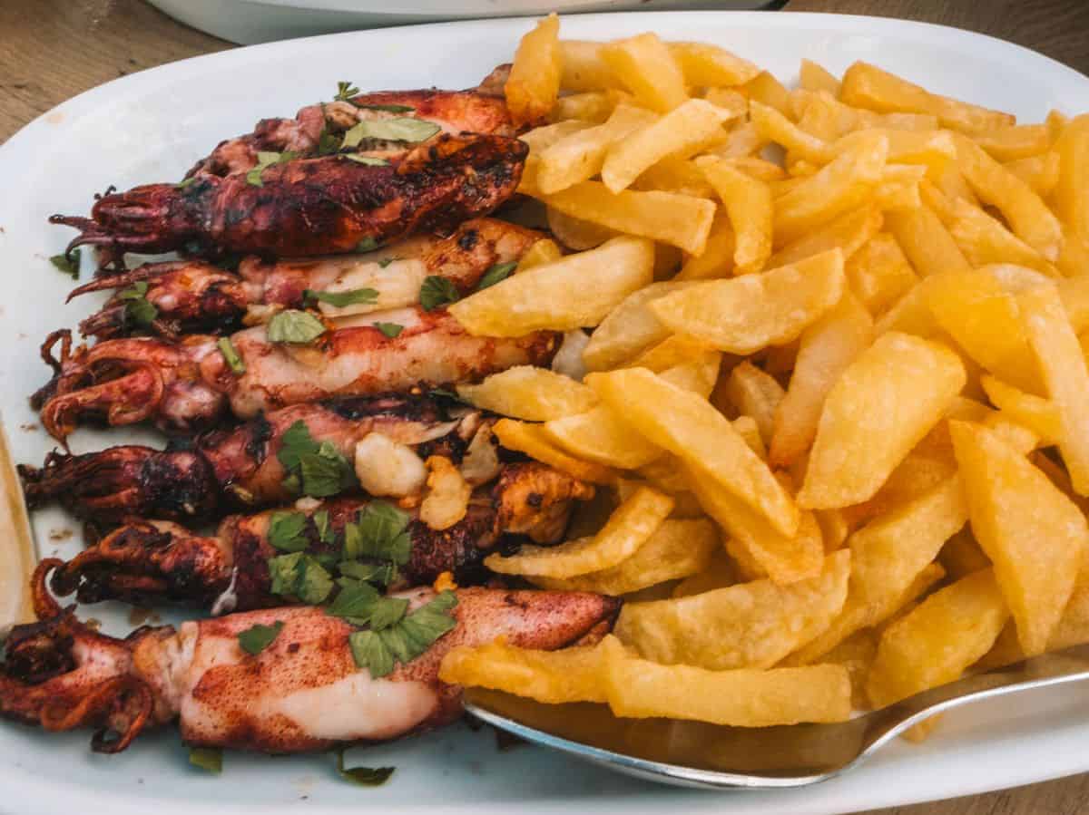 A heaping plate of pan-fried squid and french fries. 