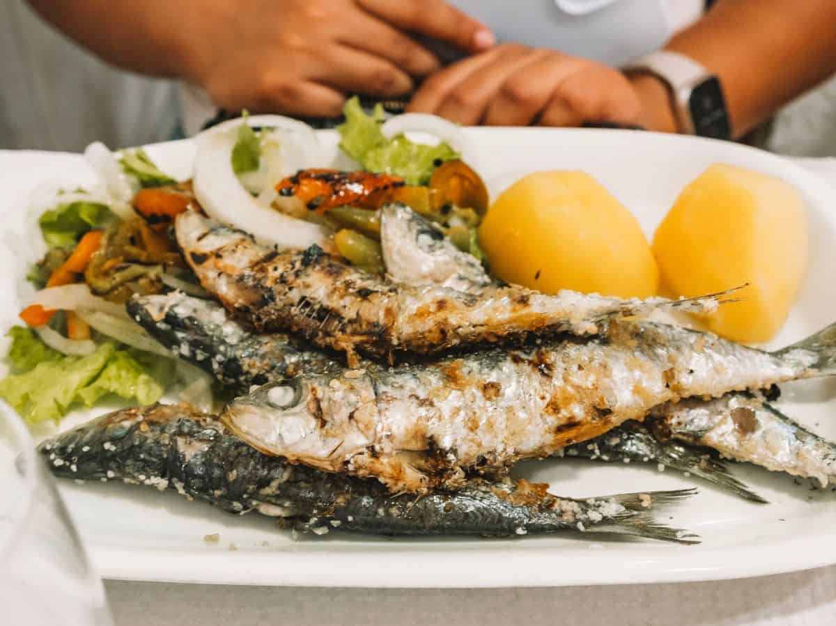 A plate of grilled sardines, salad, and boiled potatoes from Penalva da Graca in Lisbon. 