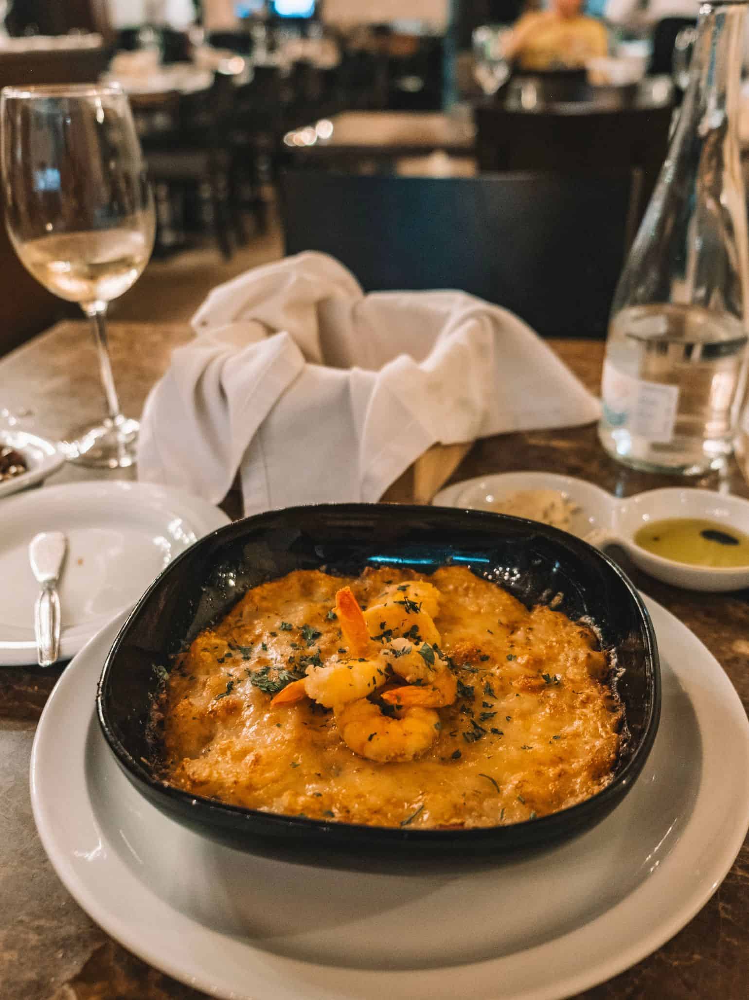 A hot bowl of bacalhau com natas com camarão salteado from A Casa do Bacalhau in Lisbon—the best restaurant in Lisbon for cod. 