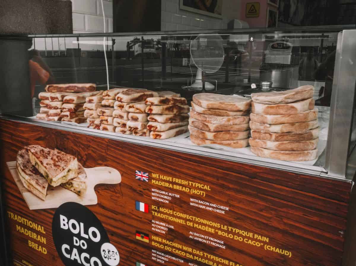 A shop selling piles of bolo do caco bread on the streets of Funchal. This is one of my personal favorite traditional Portuguese foods. 