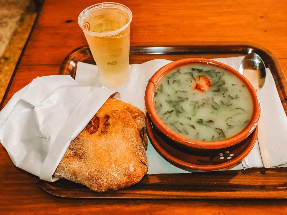 A bowl of caldo verde, pão com chouriço, and a vinho verde from A Merendiera in Lisbon. 