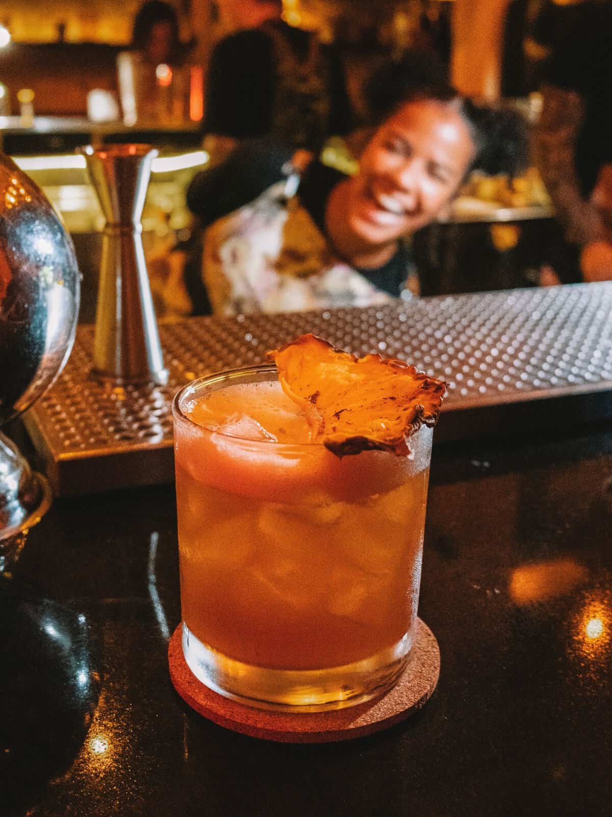 A custom cocktail from Alquimico—with the silly bartender posing in the background!