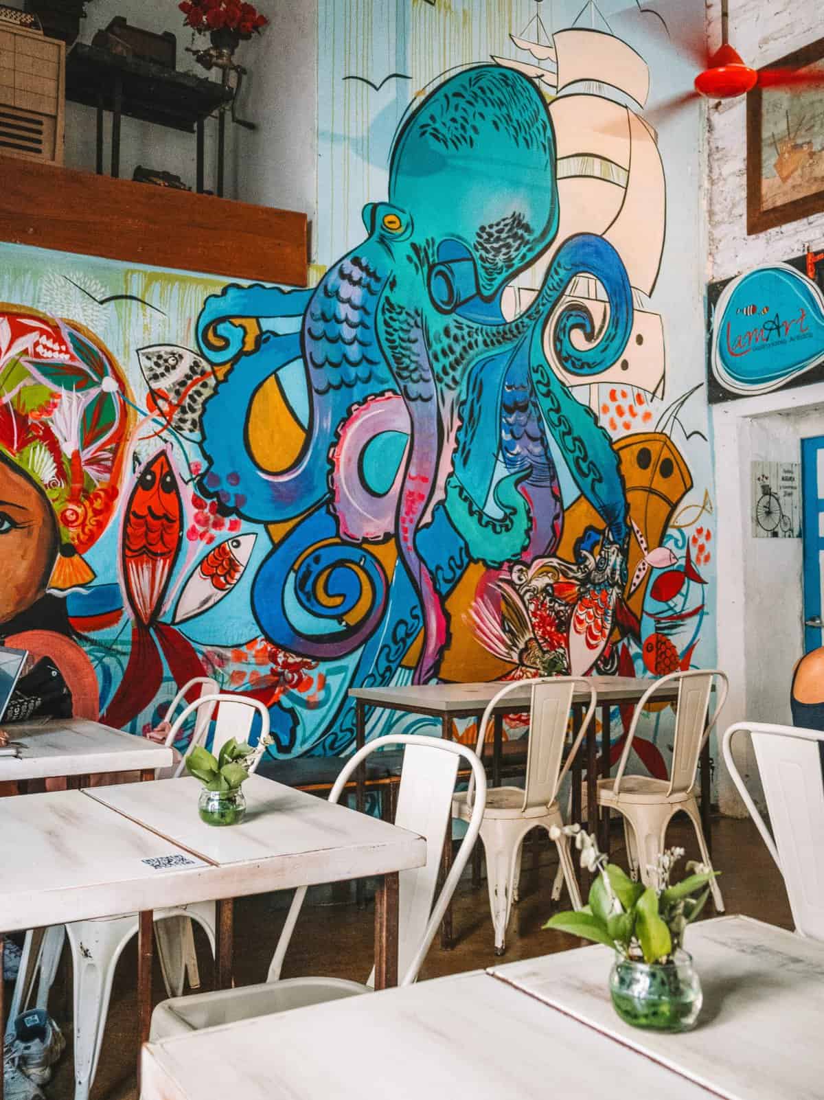 A colorful mural adorning the wall of Restaurante LaMart—one of the best restaurants in Santa Marta, Colombia.