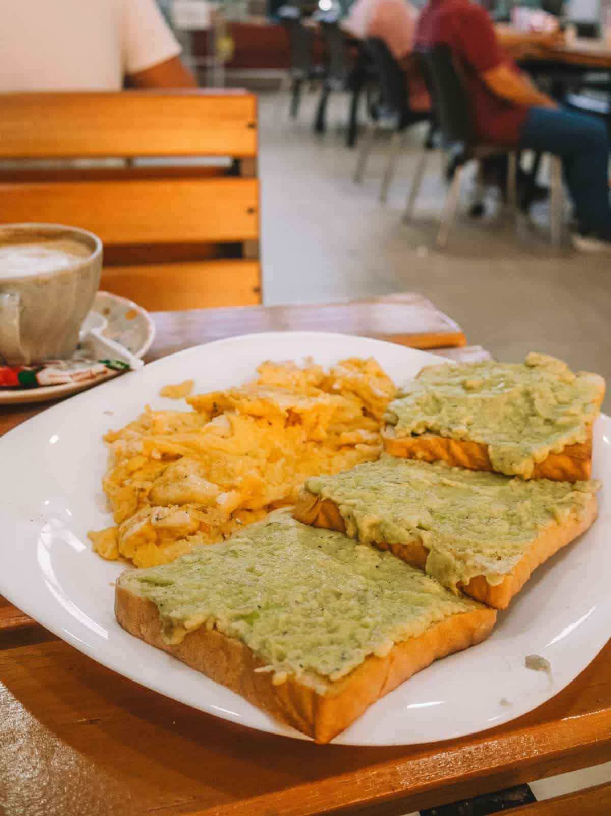 Avocado toast and scrambled eggs from Mas Que Pan—one of the best restaurants in Santa Marta, Colombia for cheap eats. 