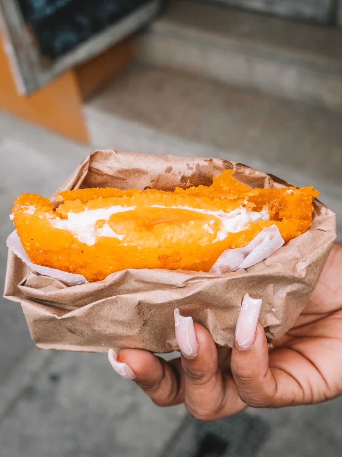 An arepa con huevo from Fritos la Mona that we tried on our street food tour—one of the best things to do in Cartagena.