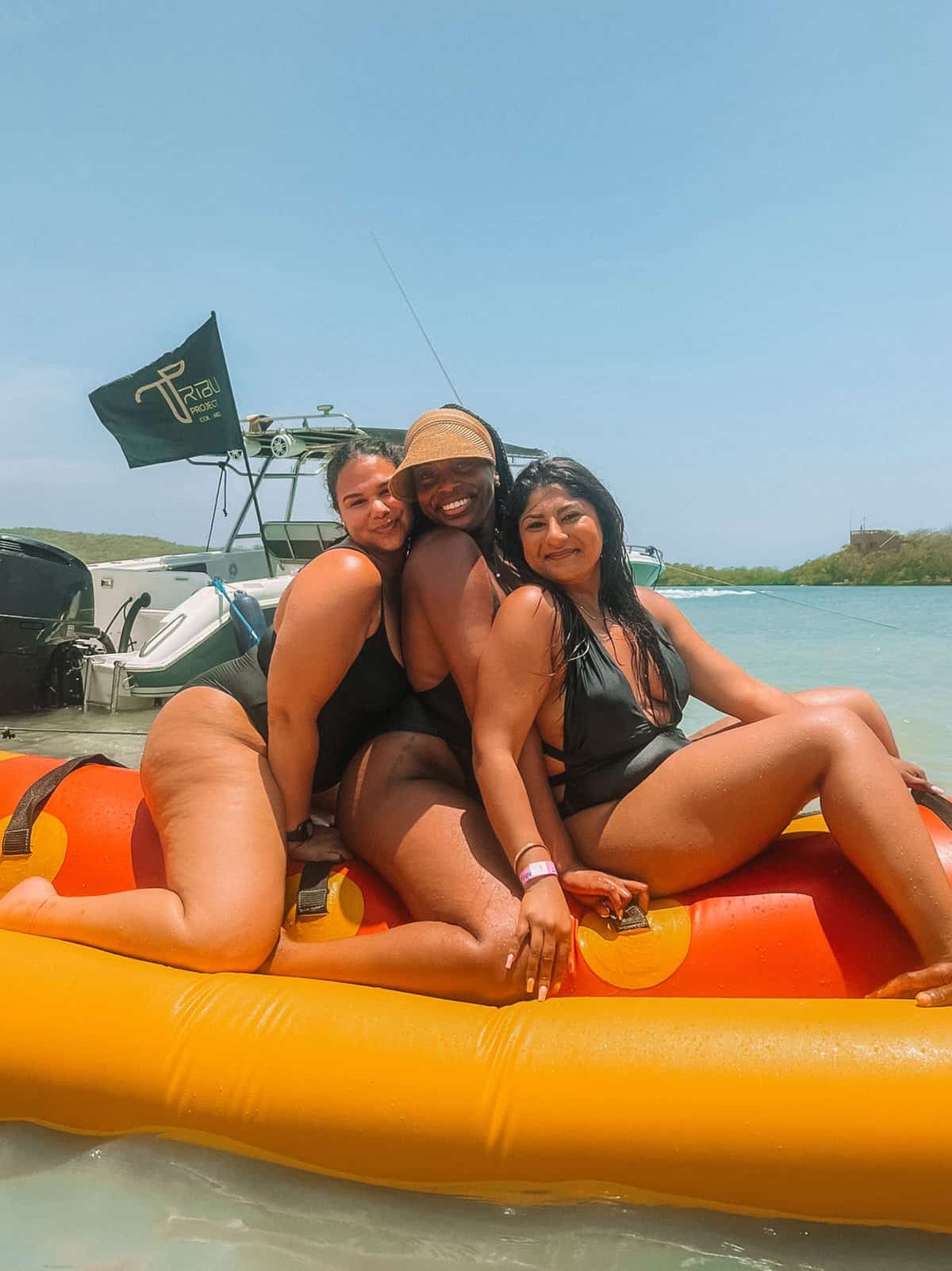 My friends smiling on a banana boat at Cholon Island during our island tour—which is one of the best things to do in Cartagena.