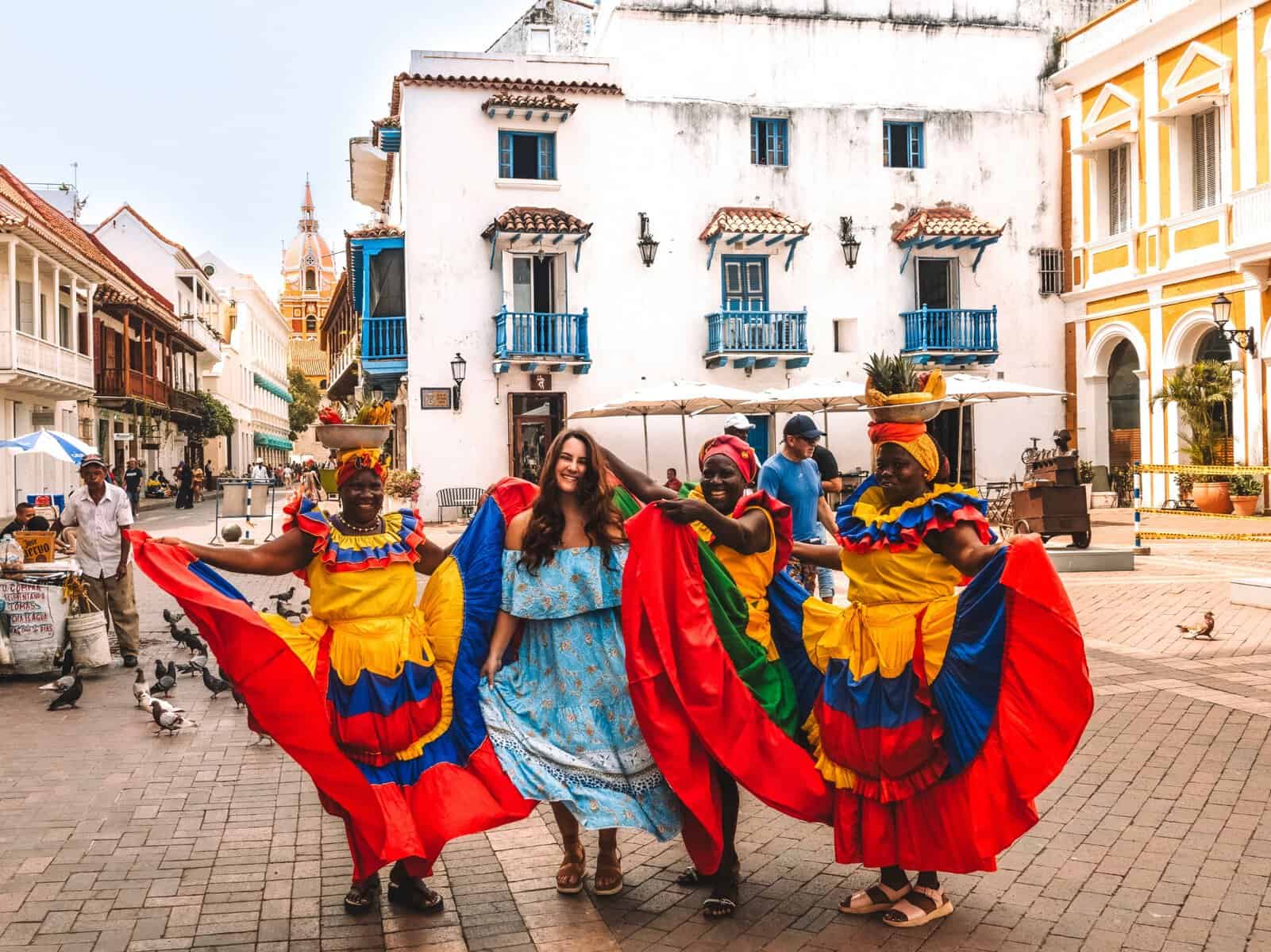 Me dancing with three palenqueras on the streets of Cartagena. Getting your photo taken with the palenqueras is absolutely one of the best things to do in Cartagena!