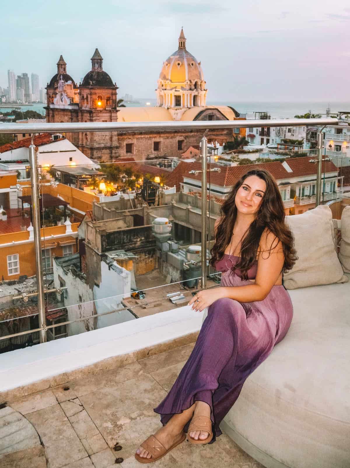 Me smiling at the Movich Hotel Rooftop Bar with gorgeous views of Cartagena in the background.